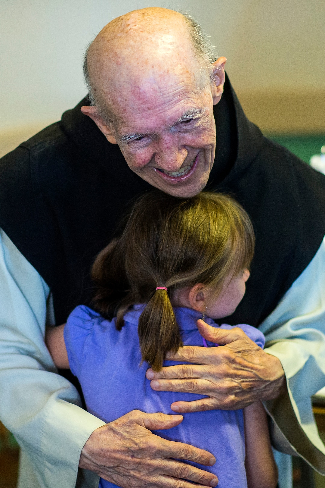 (Chris Detrick  |  The Salt Lake Tribune)  "Father Patrick" Boyle hugs Avery Vore, 6, of Farr West, in the bookstore and gift shop at the Abbey of Our Lady of the Holy Trinity in Huntsville on Wednesday, Aug. 23, 2017.