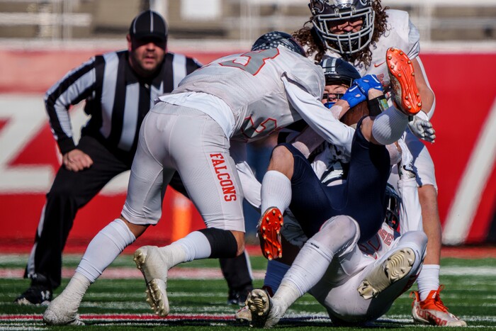 (Trent Nelson  |  The Salt Lake Tribune) Skyridge defenders take down Corner Canyon's Tank Mitchell (5) in the 6A high school football championship game at Rice-Eccles Stadium in Salt Lake City on Friday, Nov. 18, 2022.