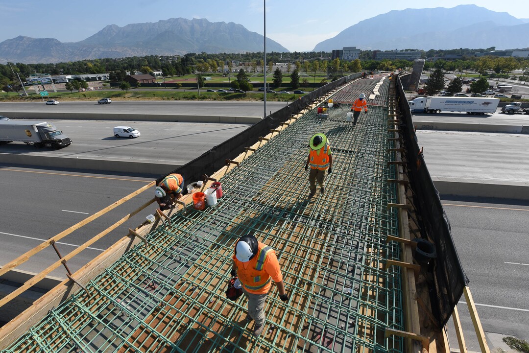 (Francisco Kjolseth  |  The Salt Lake Tribune) UDOT gives a tour of the state’s new longest pedestrian bridge on Thursday, August 20, 2020, connecting Utah Valley University in Orem to student housing and the community on the West side of I-15. Crews are finishing up an extensive hydronic heating system that will pump warm water to keep the bridge clear of snow in the winters, as it gets ready to pour concrete for the walking surface. UDOT will close I-15 in both directions this weekend for work on the nearly 1,000 foot bridge that is 15 feet wide to accommodate pedestrians, cyclists and scooters. Elevators and stairs with small ramps to push up bicycles will be on each side of the bridge.