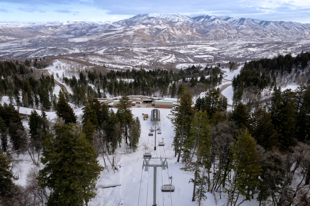 (Francisco Kjolseth | The Salt Lake Tribune) A ski lift at the exclusive and private ski and golf resort of Wasatch Peaks Ranch is pictured above the hamlet of Peterson in Morgan County on Wednesday, Dec. 13, 2023. A judge recently issued a preliminary injunction forcing the luxury resort to halt sales and construction.
