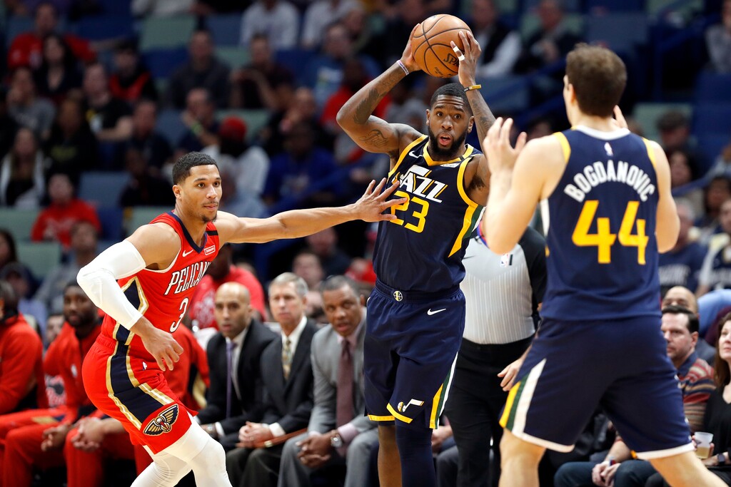 Utah Jazz forward Royce O'Neale (23) looks to pass the ball to forward Bojan Bogdanovic (44) while defended by New Orleans Pelicans guard Josh Hart (3) in the first half of an NBA basketball game in New Orleans, Monday, Jan. 6, 2020. (AP Photo/Tyler Kaufman)