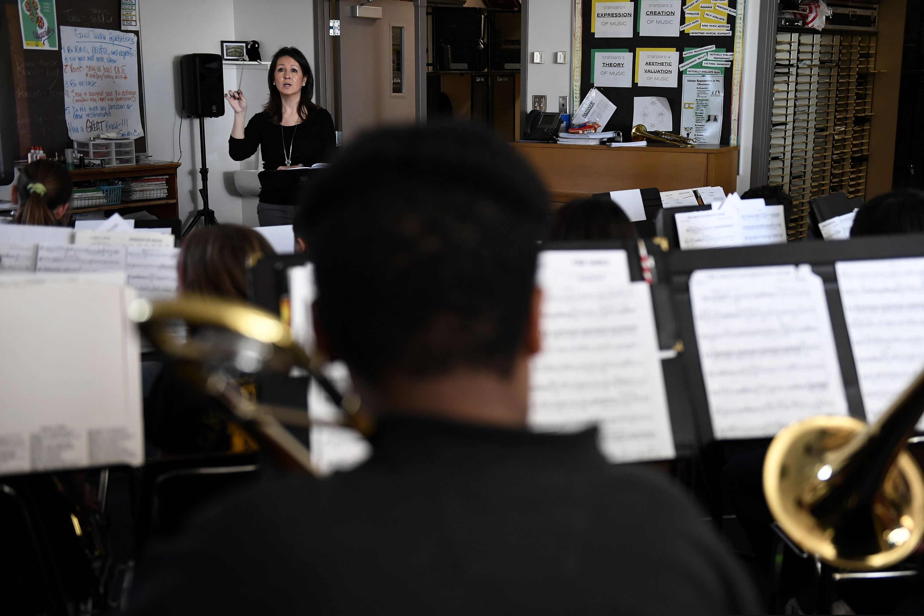 Michelle Koyama, executive principle of Skinner and Lake Middle Schools, teaches a mix of the beginner and concert bands at the school during the first day of the Denver Public Schools teachers strike, Monday, Feb. 11, 2019, in Denver.  (Joe Amon/The Denver Post via AP)