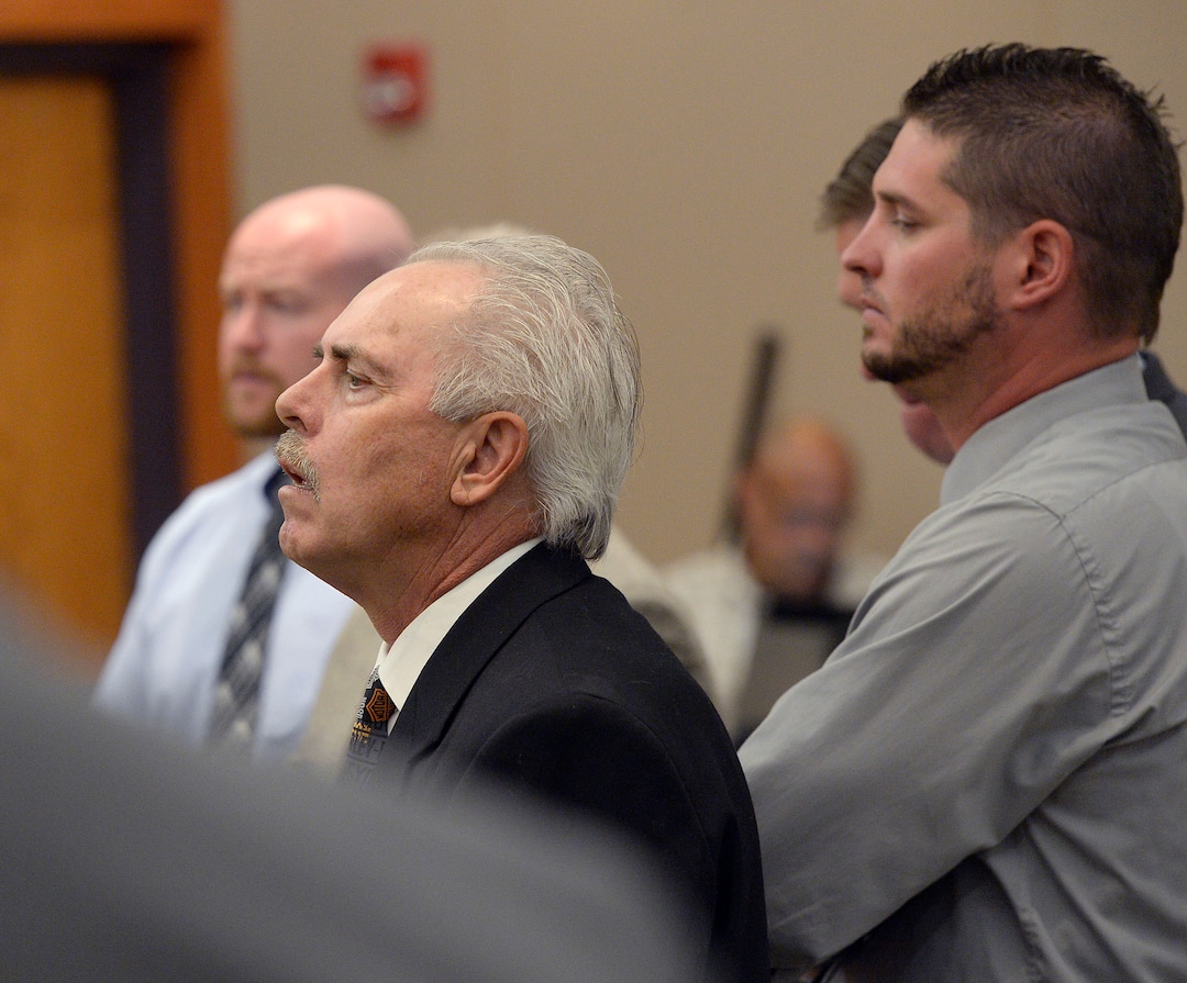 (Al Hartmann  |  Tribune file photo) Former Daggett County Sheriff Jerry Jorgensen, front left, talks with lawyers and former jail commander Lt. Benjamin Lail, right, in Third District Court in Park City on July 17, 2017 before Judge Kent Holmberg on charges connected to the abuse of jail inmates at the Daggett County jail. A third person charged at far left is Deputy Joshua Cox.