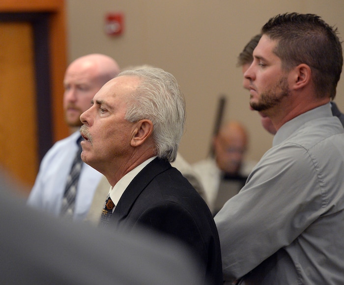 (Al Hartmann | Tribune file photo) Former Daggett County Sheriff Jerry Jorgensen, front left, talks with lawyers and former jail commander Lt. Benjamin Lail, right, in Third District Court in Park City on July 17, 2017 before Judge Kent Holmberg on charges connected to the abuse of jail inmates at the Daggett County jail. A third person charged at far left is Deputy Joshua Cox.