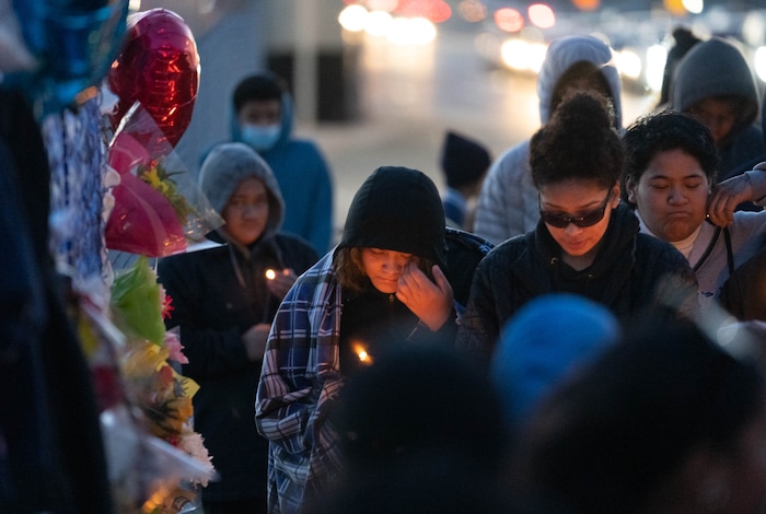 (Francisco Kjolseth | The Salt Lake Tribune) More that a hundred people gather at the candlelight vigil of Hunter High football players Paul Tahi , 15, Tivani Lopati, 14, and Ephraim Asiata, 15, on Friday, Jan 14, 2022, in West Valley City, near Hunter High School along 1400 South at Mountain View Corridor. Paul Tahi and Tivani Lopati were killed in a shooting, while Ephraim Asiata remains in critical condition.