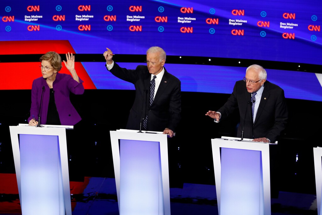 (Patrick Semansky | AP) From left, Democratic presidential candidate Sen. Elizabeth Warren, D-Mass., and former Vice President Joe Biden raise their hands as candidate Sen. Bernie Sanders, I-Vt., speaks Tuesday, Jan. 14, 2020, during a Democratic presidential primary debate hosted by CNN and the Des Moines Register in Des Moines, Iowa.