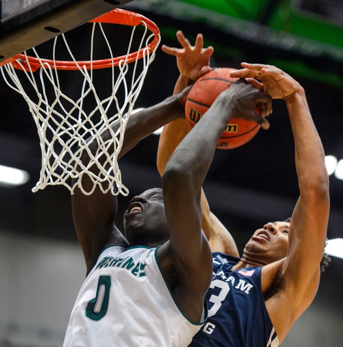 (Steve Griffin  |  The Salt Lake Tribune) Brigham Young Cougars forward Yoeli Childs (23) blocks a dunk attempt by Utah Valley Wolverines center Akolda Manyang (0) during the BYU versus UVU basketball game at UCCU Center on the UVU campus in Orem Wednesday November 29, 2017.