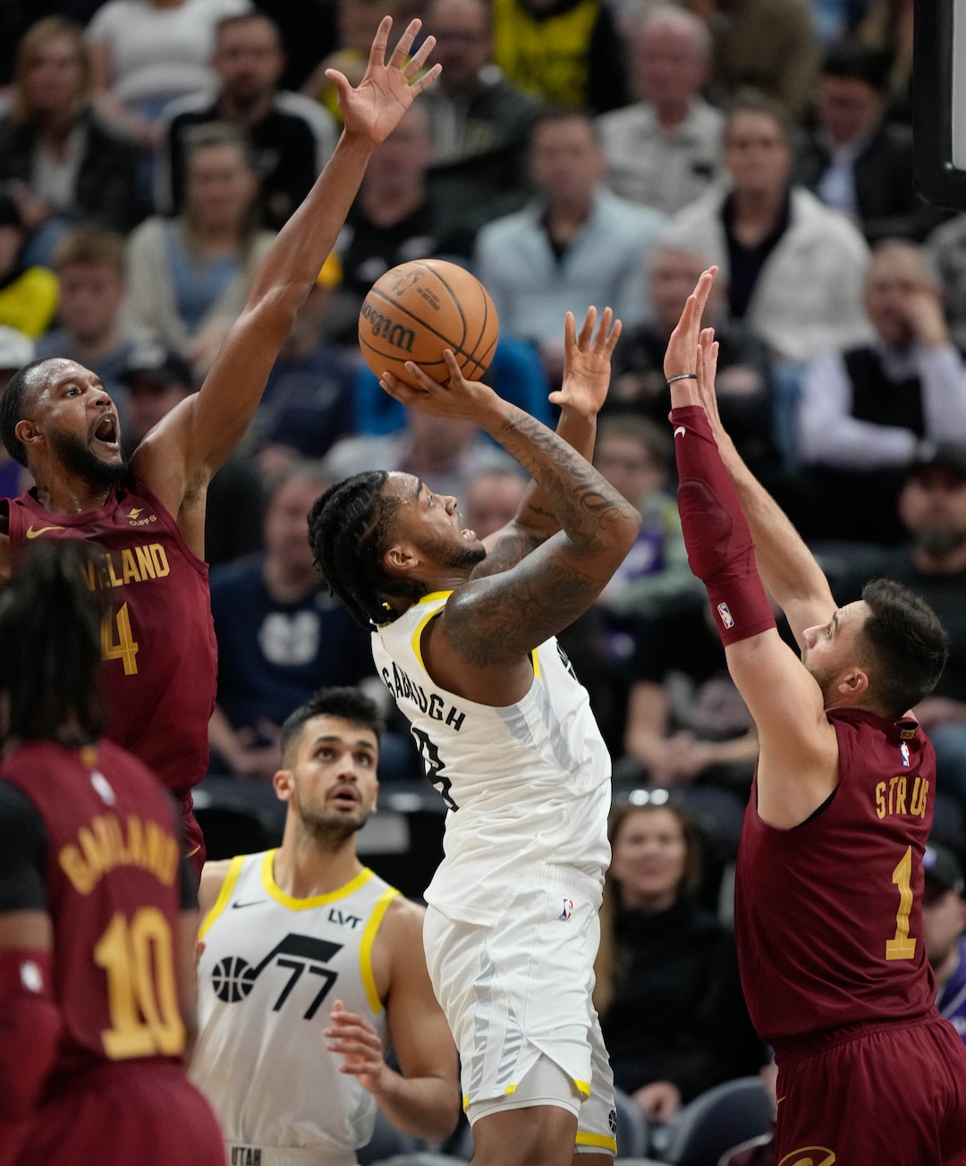 (Francisco Kjolseth  |  The Salt Lake Tribune) Utah Jazz forward Brice Sensabaugh (8) makes an attempt on the basket sandwiched between Cleveland Cavaliers forward Evan Mobley (4) and Cleveland Cavaliers guard Max Strus (1) at the Delta Center in Salt Lake City on Tuesday, April 2, 2024.