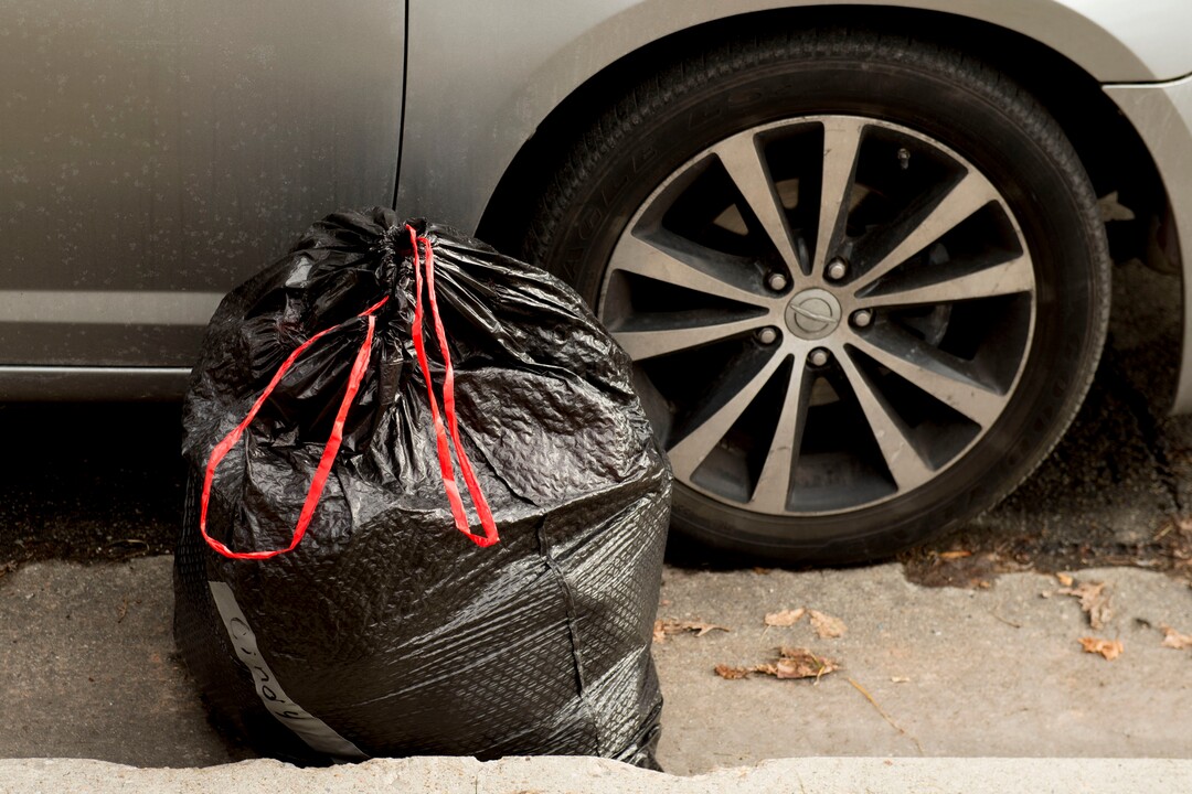 (Jeremy Harmon  |  The Salt Lake Tribune) A bag of laundry belonging to a person who had been camping at Taufer Park in Salt Lake City sits next to the car of volunteers from Addict to Advocate on Thursday, January 9, 2020. The group helps people who have to camp around the city clean up their belongings ahead of health department cleanups so they don't lose items like blankets and sleeping bags.
