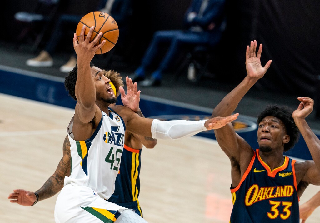 (Rick Egan | The Salt Lake Tribune) Utah Jazz guard Donovan Mitchell (45) takes the ball down court, as Golden State Warriors guard Kelly Oubre Jr. (12) and Golden State Warriors center James Wiseman (33) defend, in NBA action between the Utah Jazz and the Golden State Warriors at Vivint Arena, on  Saturday, Jan. 23, 2021.