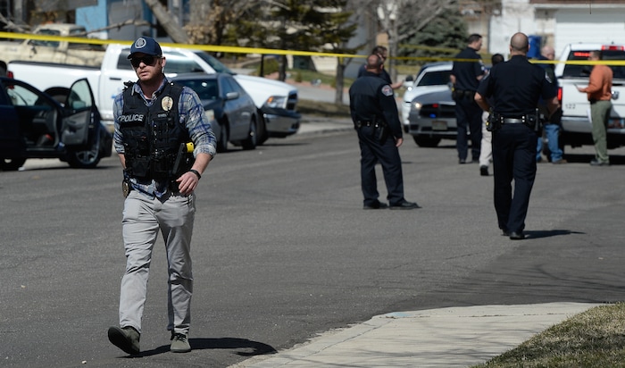 (Francisco Kjolseth | The Salt Lake Tribune) Investigators comb the scene where a Granite School District police officer shot a driver on Tuesday afternoon, March 20, 2018. While on patrol near Hunter High School, the officer noticed a car full of teenagers and smelled marijuana. When he approached the car lurched and he ended up on the hood. The driver was shot and four other teens in the car fled the scene.
