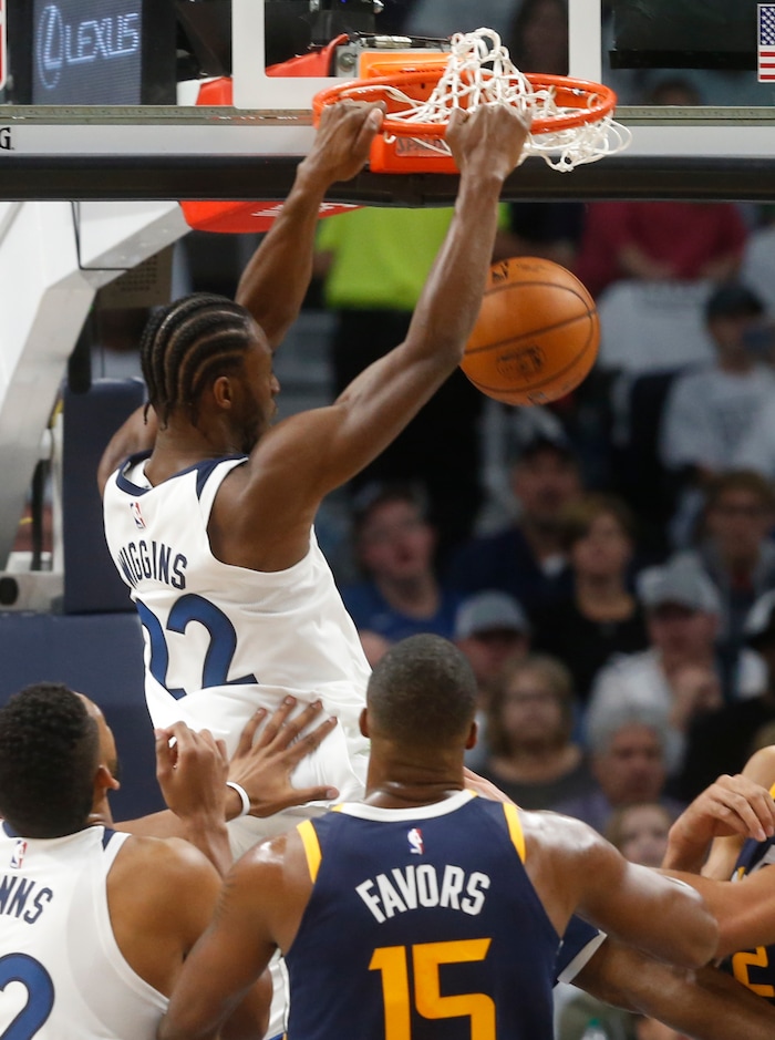 Minnesota Timberwolves' Andrew Wiggins dunks as Utah Jazz's Derrick Favors looks on during the first half of an NBA basketball game Friday, Oct. 20, 2017, in Minneapolis. AP Photo/Jim Mone)