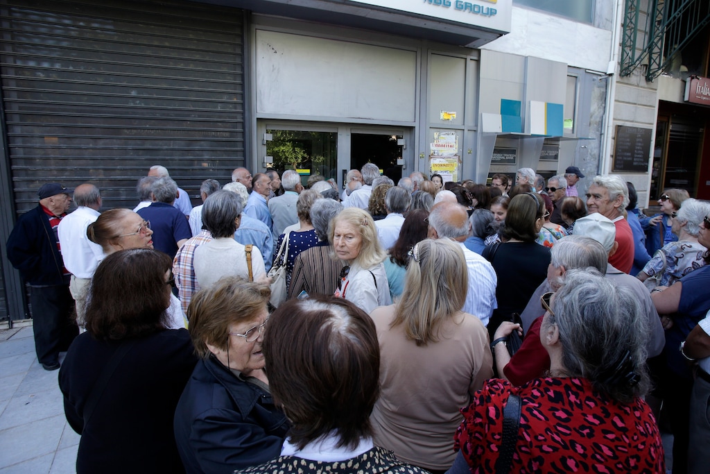 Pensioners stand in a queue outside a bank in Athens, Wednesday, July 1, 2015. About 1,000 bank branches around the country were ordered by the government to reopen Wednesday to help desperate pensioners without ATM cards cash up to 120 euros ($134) from their retirement checks. Eurozone finance ministers were set to weigh Greece's latest proposal for aid Wednesday. (AP Photo/Thanassis Stavrakis)