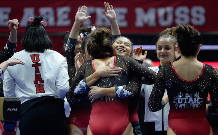 (Francisco Kjolseth  |  The Salt Lake Tribune)  Adrianne Randall is hugged by teammates following her routine on the balance beam as Utah hosts Penn State in their season opener at the Huntsman Center in Salt Lake City on Saturday, Jan. 5, 2019.