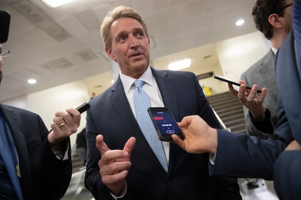 Sen. Jeff Flake, R-Ariz., speaks with reporters at the Capitol in Washington, Wednesday, Nov. 14, 2018. (AP Photo/J. Scott Applewhite)