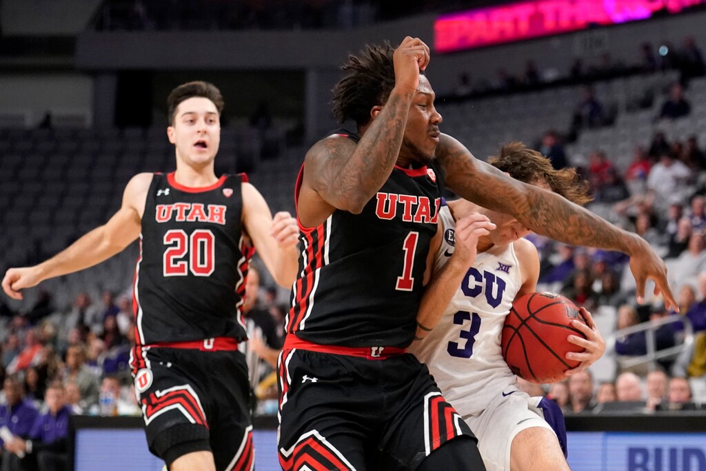 Utah's Lazar Stefanovic (20) looks on as David Jenkins Jr. (1) fouls TCU's Francisco Farabello (3) on a drive to the basket in the first half of an NCAA college basketball game in Fort Worth, Texas, Wednesday, Dec. 8, 2021. A technical foul was issued on the play. (AP Photo/Tony Gutierrez)