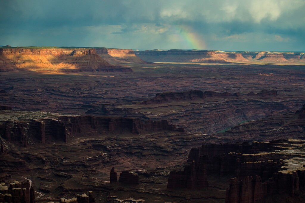 (Chris Detrick  |  Tribune file photo) A rainbow appears in the distance as seen from Grand View Point in the Island in the Sky District at Canyonlands National Park in August 2016.
