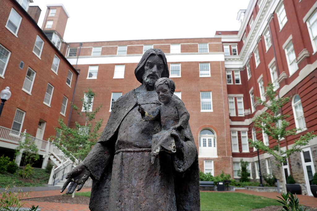 (Jacquelyn Martin | AP file photo)

In this Sept. 1, 2016, photo, a Jesuit statue is seen in front of Freedom Hall, formerly named Mulledy Hall, on the Georgetown University campus in Washington. Georgetown University and two theological seminaries have announced plans for reparations to benefit descendants of the enslaved people who played a role in the institutions' success. At least 56 universities have joined a University of Virginia-led consortium, Universities Studying Slavery, to explore their ties to slavery and share research and strategies.