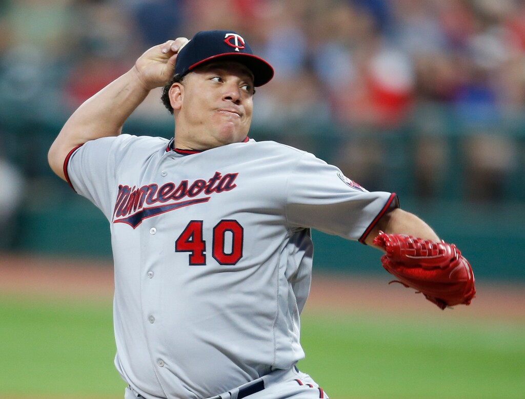 File-This Sept. 26, 2017, file photo shows Minnesota Twins starting pitcher Bartolo Colon throwing against the Cleveland Indians during the first inning in a baseball game in Cleveland. Colon has agreed to a minor league contract with the Texas Rangers, and the 44-year-old right-hander will attend big league spring training. Colon would get a $1.75 million, one-year contract if added to the 40-man roster under the terms of the deal agreed to Sunday, Feb. 4, 2018.  (AP Photo/Ron Schwane, File)