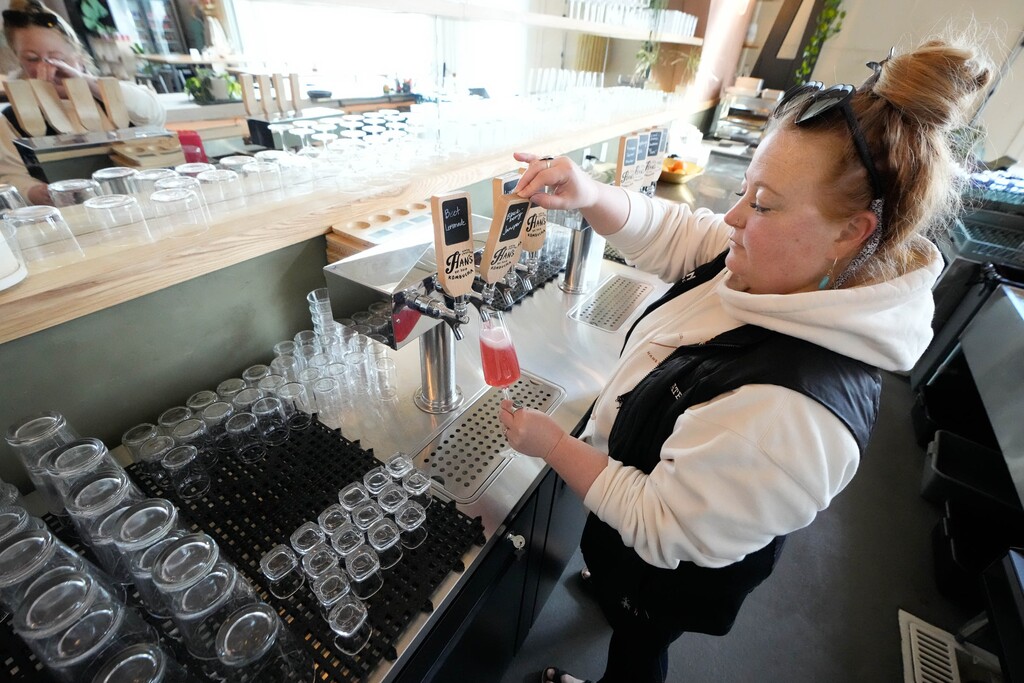 (Francisco Kjolseth | The Salt Lake Tribune) Kate Lubing, co-owner and operations director of HK Brewing Collective, pours a sample of their popular blackberry juniper flavor at 370 Aspen Ave. in Salt Lake City on Tuesday, March 28, 2023.