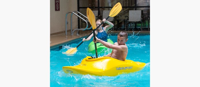 (Rick Egan | The Salt Lake Tribune) Samantha Moore and Braxton Moore, race kayaks across the swimming pool at Ruby's Inn, during the kayak demonstration at the 36th annual Bryce Canyon Winter Festival on Saturday, Feb. 13, 2021.