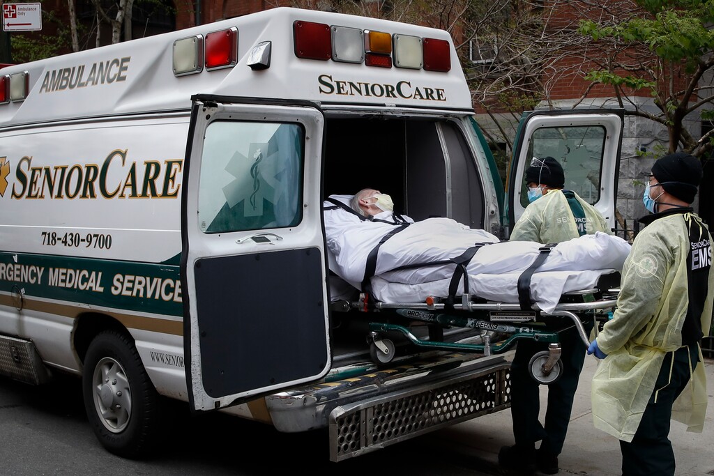 (John Minchillo | AP photo)
In this April 17, 2020, photo, a patient is loaded into an ambulance by emergency medical workers outside Cobble Hill Health Center in the Brooklyn borough of New York. More than 9,000 recovering coronavirus patients in New York state were released from hospitals into nursing homes at the height of the pandemic under a controversial order that was scrapped amid criticisms it accelerated outbreaks, according to records obtained by The Associated Press.