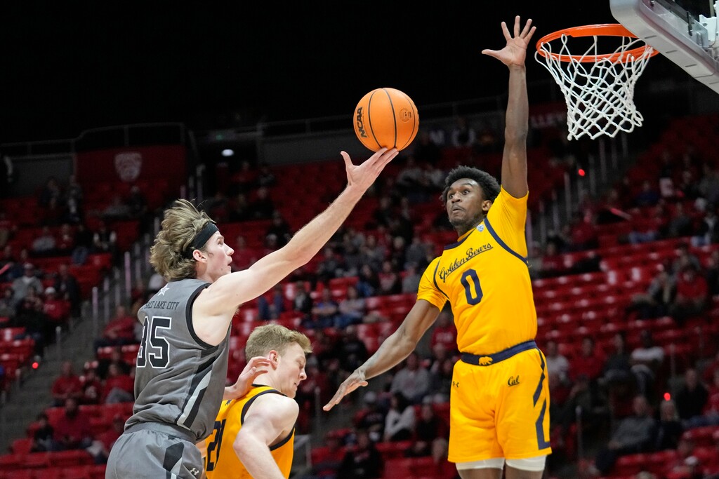 Utah center Branden Carlson (35) goes to the basket as California guard Marsalis Roberson (0) defends during the second half of an NCAA college basketball game Sunday, Feb. 5, 2023, in Salt Lake City. (AP Photo/Rick Bowmer)