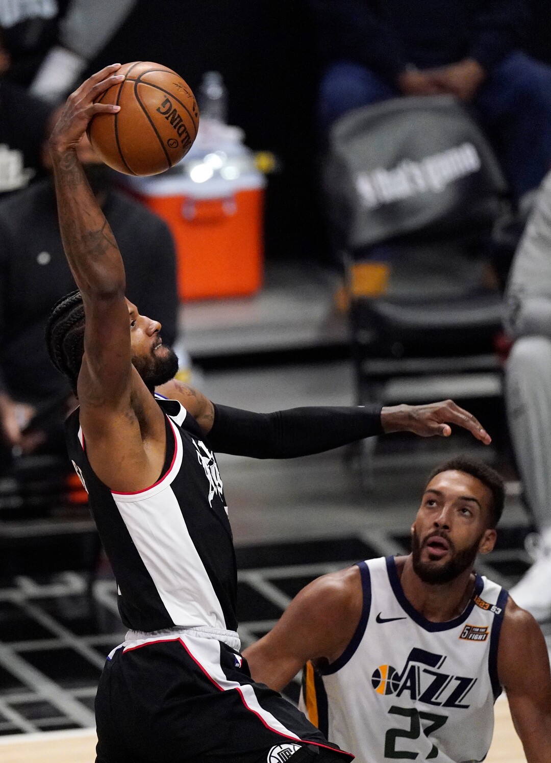 Los Angeles Clippers guard Paul George, left, dunks as Utah Jazz center Rudy Gobert watches during the second half of Game 3 of a second-round NBA basketball playoff series Saturday, June 12, 2021, in Los Angeles. (AP Photo/Mark J. Terrill)