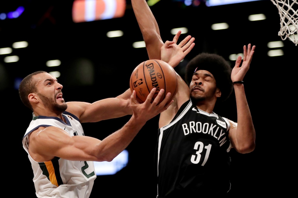 Utah Jazz center Rudy Gobert, left, goes up for a shot against Brooklyn Nets center Jarrett Allen during the second half of an NBA basketball game, Wednesday, Nov. 28, 2018, in New York. The Jazz won 101-91. (AP Photo/Julio Cortez)