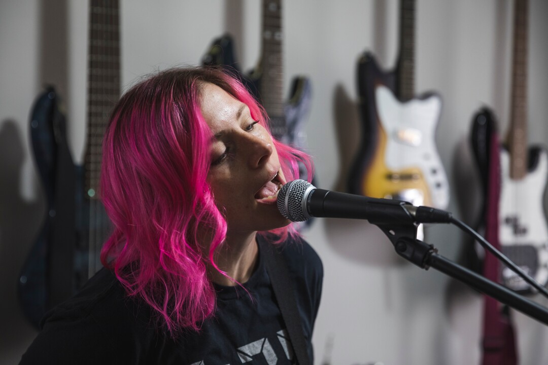 (Clark Clifford  |  For The Salt Lake Tribune) Elaine Bradley of Noble Bodies sings into the microphone during practice for an upcoming show in the band's rehearsal space in Orem on Saturday, Aug. 3, 2019.