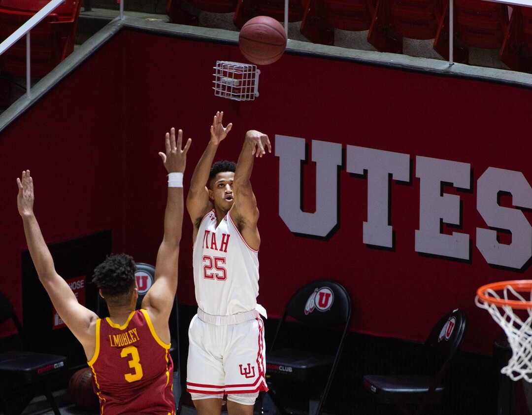 (Francisco Kjolseth  | The Salt Lake Tribune) Utah Utes guard Alfonso Plummer (25) shoots for three points past USC Trojans forward Isaiah Mobley (3) in PAC-12 basketball action at the Jon M. Huntsman Center, on Saturday, Feb. 27, 2021.