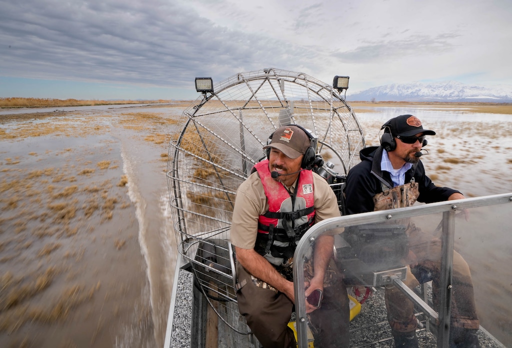 (Francisco Kjolseth | The Salt Lake Tribune) Ogden Bay Waterfowl Manager Rich Hansen, left, and Ducks Unlimited Regional Director Chad Yamane use an air boat to glide over the shallows of Ogden Bay, checking on repair projects to restore critical Great Salt Lake wetlands on Wednesday, April 12, 2023.