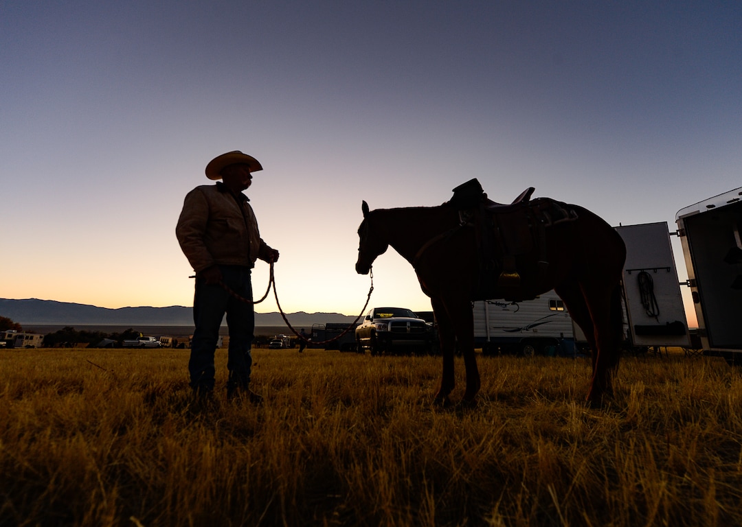 (Francisco Kjolseth  |  The Salt Lake Tribune)  Terry Yates of Ogden spends a quiet moment with Crazy Allice as the sun rises on the 33rd annual Bison Roundup, Saturday, Oct. 26, 2019, on Antelope Island, a state park located near Syracuse in Davis County. Every year Utah wildlife and parks officials move the animals from across the island so they can be weighed, tagged and given health screenings.