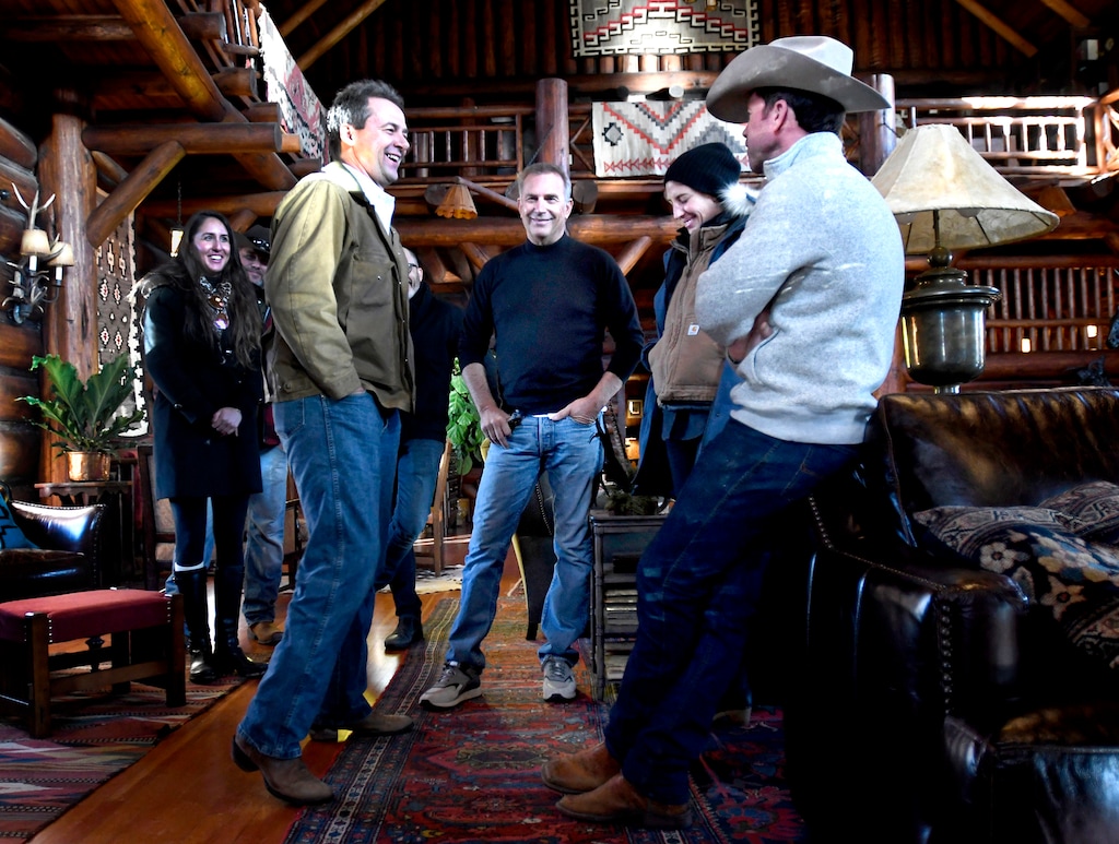 (Kurt Wilson | The Missoulian | The Associated Press) In this Dec. 7, 2017 photo, Montana Gov. Steve Bullock, foreground from left, appears with actor Kevin Costner, production designer Ruth De Jong and writer-director Taylor Sheridan in the lodge at the Chief Joseph Ranch during a visit to the set of the television series "Yellowstone" in Darby, Mont. The series is set for release in June.
