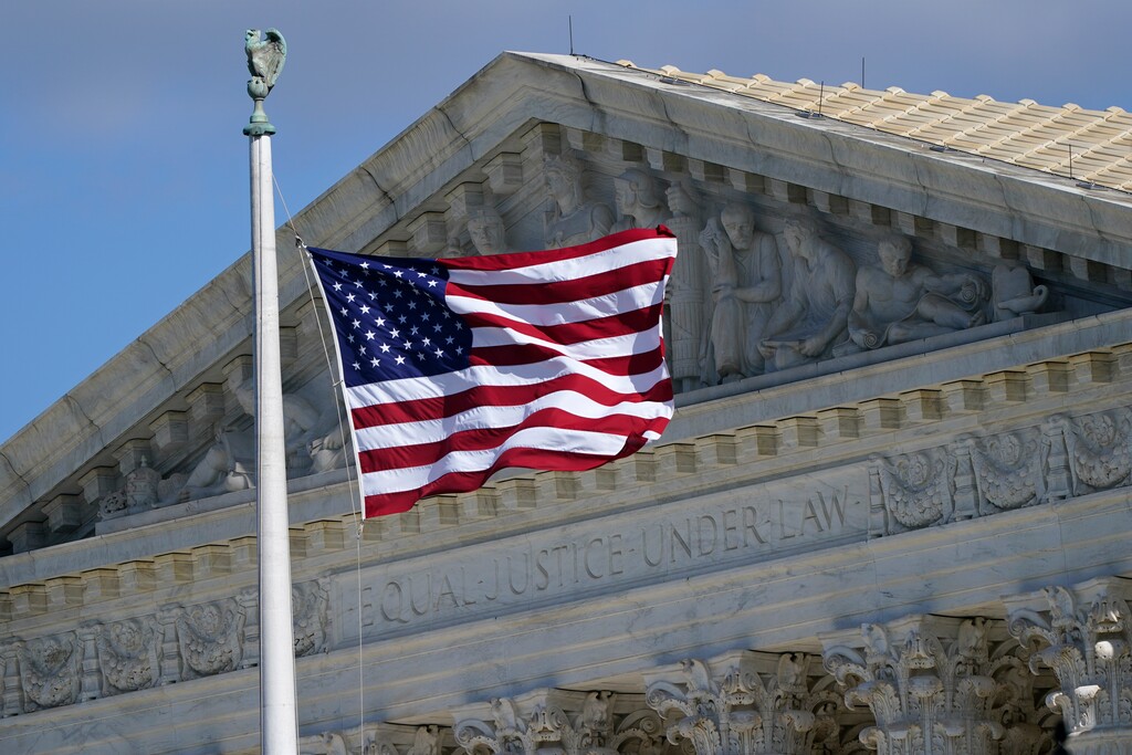 (Patrick Semansky | AP file photo)  An American flag waves in front of the Supreme Court building, Monday, Nov. 2, 2020, on Capitol Hill in Washington.