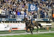 (Eli Lucero | Herald Journal) A member of the school's rodeo team carries a flag around Maverik Stadium before Utah State plays Nevada on Saturday, Nov. 8, 2025, in Logan.