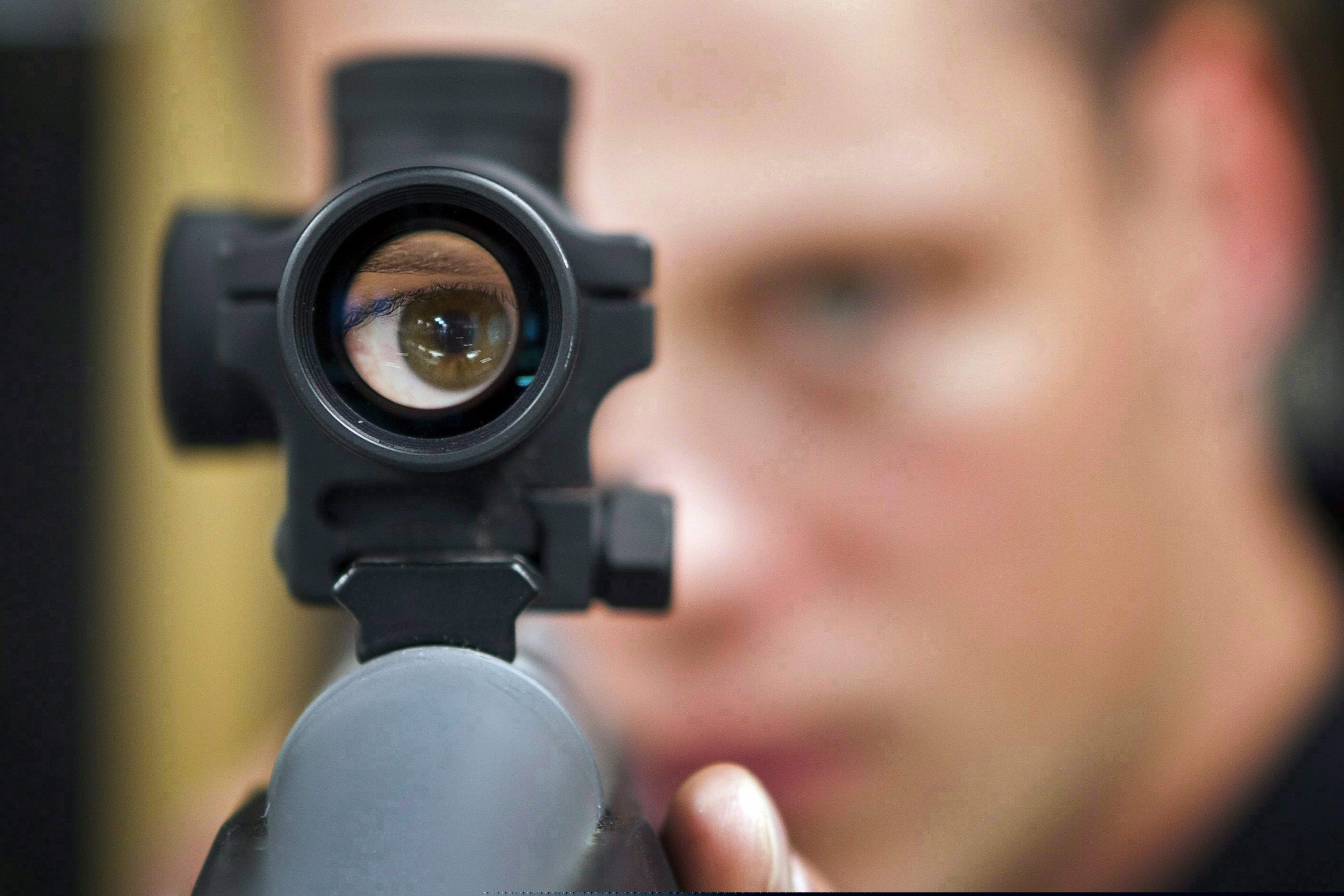 (Jeff McIntosh | The Canadian Press via AP)

In this Sept. 15, 2010 file photo, an employee looks through the scope of long gun at a gun store in Calgary, Alberta, Canada.