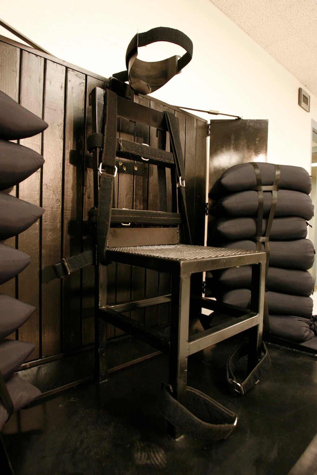 Trent Nelson | The Salt Lake Tribune
Draper - The execution chamber at the Utah State Prison after Ronnie Lee Gardner was executed by firing squad Friday, June 18, 2010. Four bullet holes are visible in the wood panel behind the chair. Gardner was convicted of aggravated murder, a capital felony, in 1985.