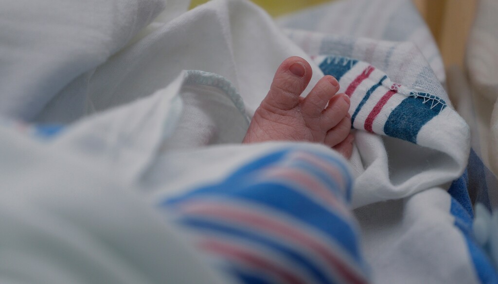 (Eric Gay | The Associated Press) In this file photograph, the toes of a baby who born on July 29, 2020 can be seen beneath a hospital blanket.