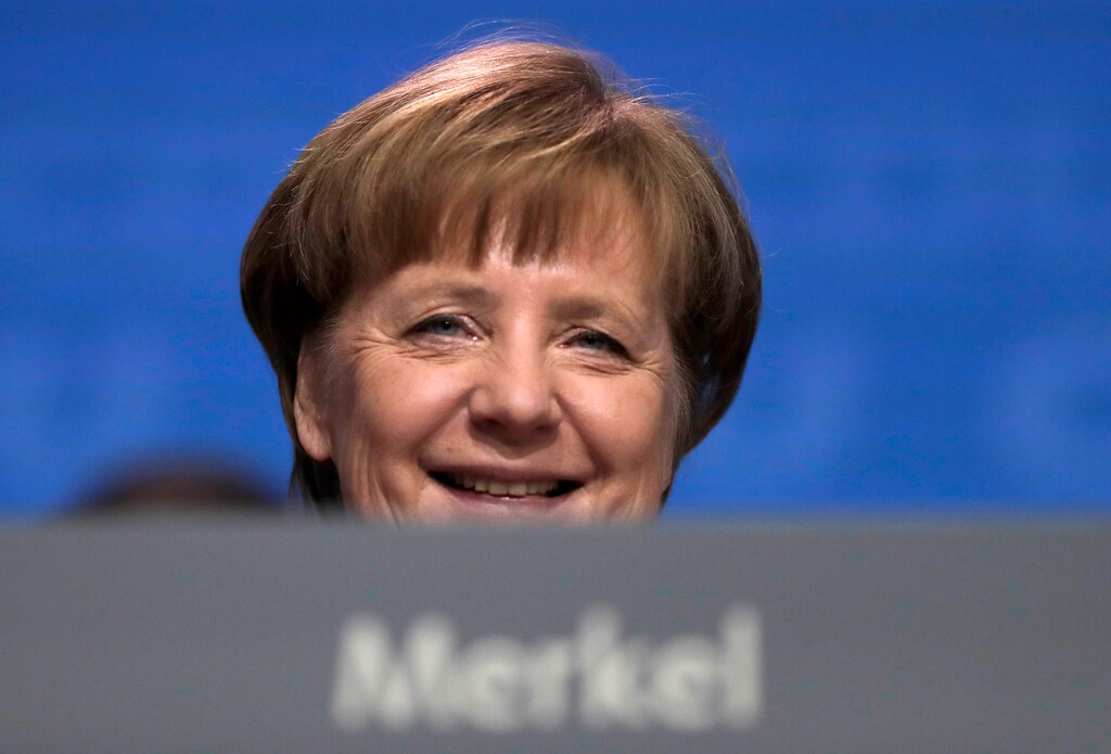 FILE - In this Feb. 26, 2018, file photo, German Chancellor and party chairwoman Angela Merkel smiles at the party convention of the Christian Democratic Union in Berlin. The members of the Social Democratic party voted for a coalition agreement with Merkel's party, paving the way for Merkel's fourth term as chancellor.  (AP Photo/Markus Schreiber, file)