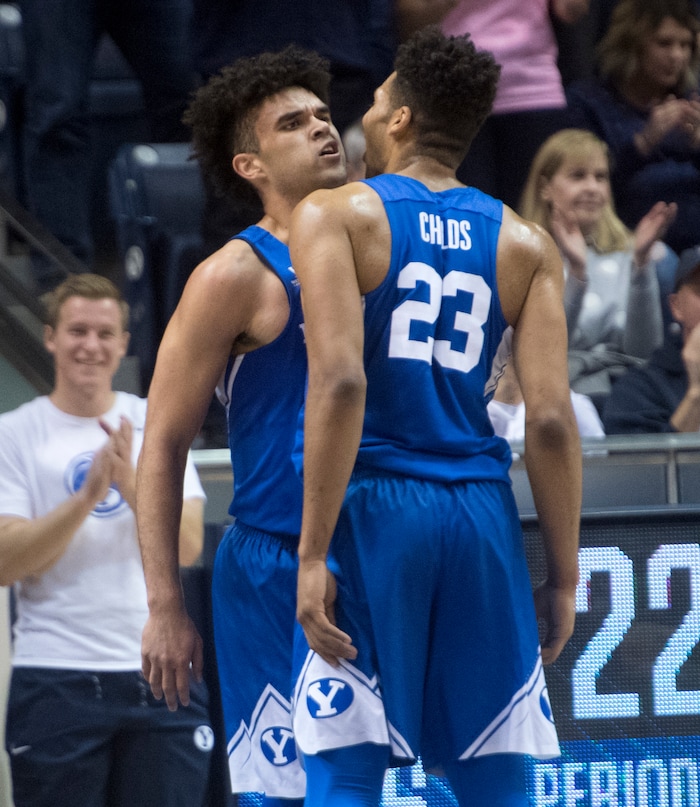 (Rick Egan  |  The Salt Lake Tribune) Brigham Young forward Yoeli Childs (23) and Brigham Young guard Elijah Bryant (3) celebrates 35-22 Cougar lead, in basketball action Utah Utes vs. Brigham Young Cougars at the Marriott Center in Provo, Saturday, December 15, 2017.



