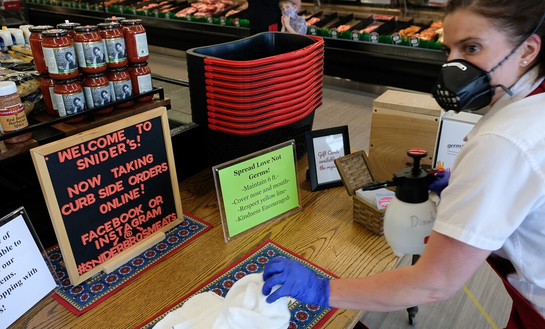 (Francisco Kjolseth  |  The Salt Lake Tribune) Rachael Wilson does one of her regular cleaning runs throughout the store at Snider Brothers Meats in Cottonwood Heights on Tuesday, May 5, 2020, where her parents Will and Amy Wilson, have been requiring that all customers wear masks or facial coverings when they come to shop. They say it's important to protect their employees, several of whom are the sole breadwinners at home and have at-risk family members.