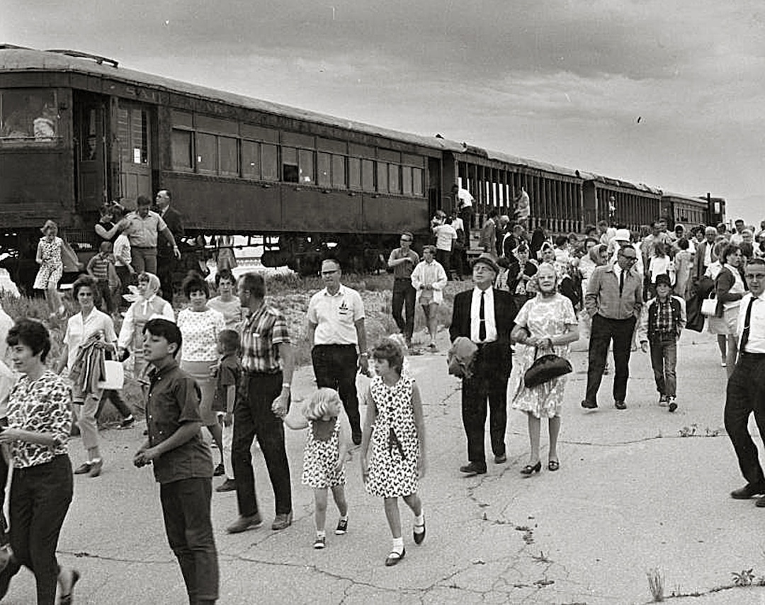 (Utah State Historical Society) Saltair enthusiasts exit the train from Salt Lake City to Saltair in July 1966. The ride and subsequent fundraising efforts that year was an attempt to refurbish the dilapidated resort that had been shuttered for 8 years. The fundraising effort failed and the resort burned to the ground 4 years later after it was set ablaze by an arsonist.