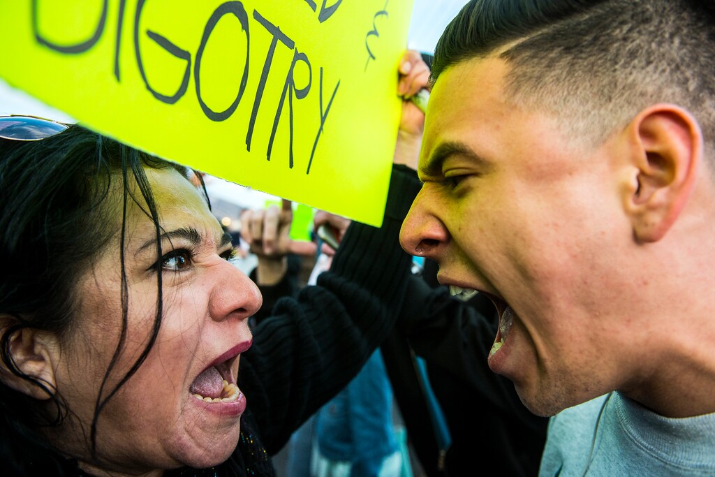 (Chris Detrick  |  The Salt Lake Tribune) A protester and supporter of Republican presidential candidate Donald Trump argue outside of the Infinity Event Center Friday March 18, 2016. 