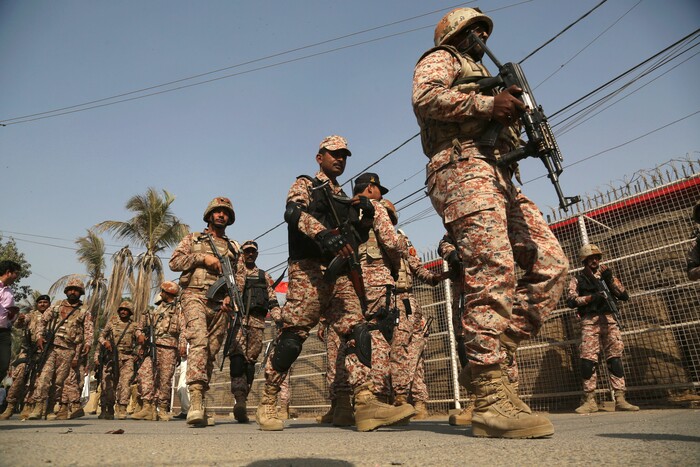 Pakistani troops move in the compound of Chinese Consulate in Karachi, Pakistan, Friday, Nov. 23, 2018. Pakistani police say gunmen have stormed the Chinese Consulate in the country's southern port city of Karachi, triggering an intense shootout. (AP Photo/Shakil Adil)