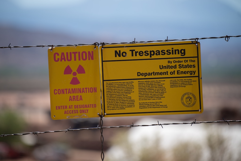 (Trevor Christensen | The Salt Lake Tribune) A sign marks the border of the Utah Moab Uranium Mill Tailings Remedial Action (UMTRA) Project, located just outside Moab on the banks of the Colorado River, on Aug. 14, 2024. The cleanup of waste from the former uranium mill continues as companies propose reopening another mill in Utah and building a new one, spurred by higher uranium prices and interest in nuclear power.