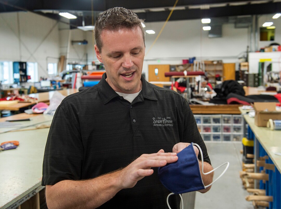 (Rick Egan  |  The Salt Lake Tribune)     Mike Peterson, president of SugarHouse Industries explains how they are using their industrial cutting and sewing machines to make face masks and face shields, to protect against coronavirus, Thursday, March 26, 2020.