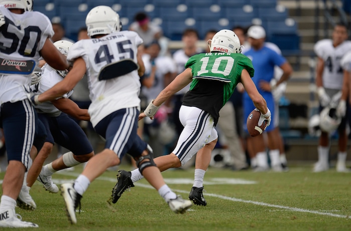 (Francisco Kjolseth  |  The Salt Lake Tribune)  Quarterback Koy Detmer jr. is pressured by the defense as BYU holds a scrimmage at LaVell Edwards Stadium in Provo on Thursday, Aug. 10, 2017.