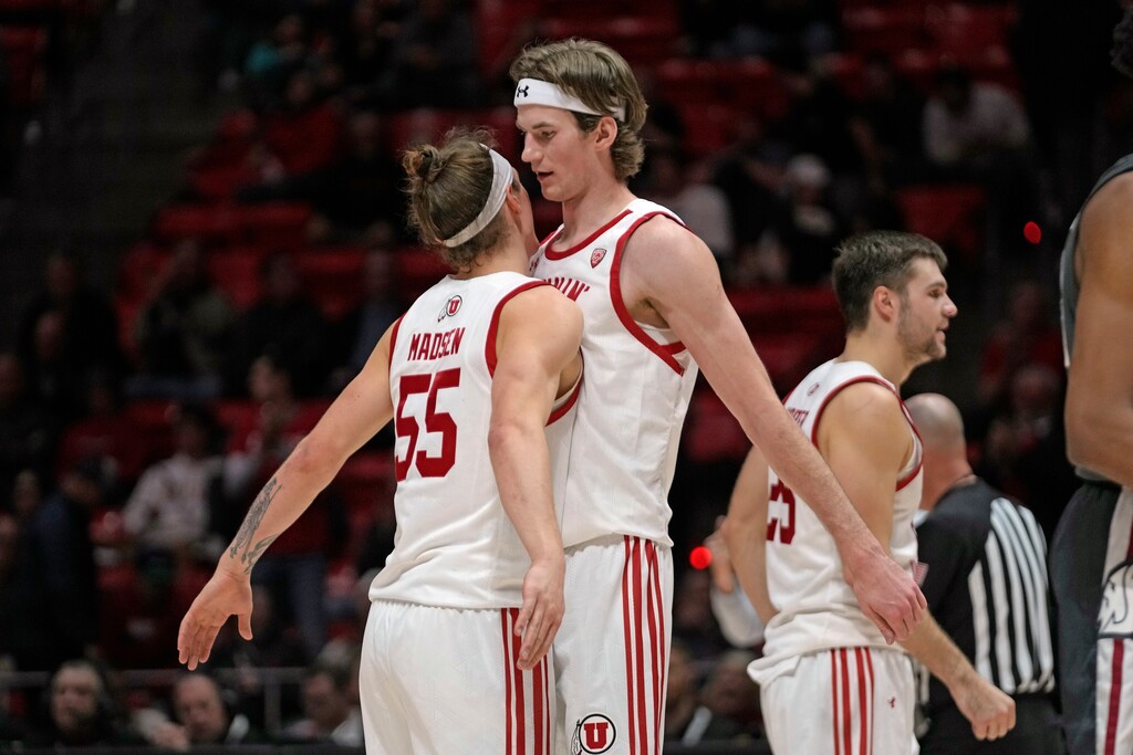 Utah's Branden Carlson, front right, celebrates with Gabe Madsen (55) after scoring a 3-point basket and being fouled by Washington State during the second half of an NCAA college basketball game Thursday, Jan. 19, 2023, in Salt Lake City. (AP Photo/Rick Bowmer)