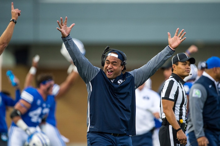 (Chris Detrick  |  The Salt Lake Tribune)  Brigham Young Cougars running backs coach Reno Mahe celebrates a touchdown during the game at Merlin Olsen Field at Maverik Stadium Friday, September 29, 2017.